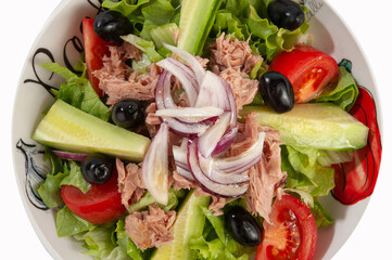 Salad with ham, tomatoes, eggs, olives, yellow cheese and onion