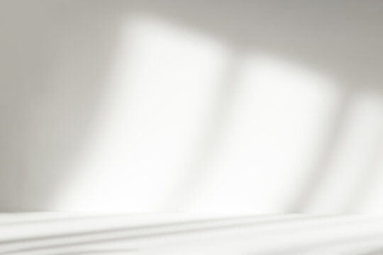 Abstract white studio background with shadows of window. Empty 3d room. Display product with blurred backdrop.