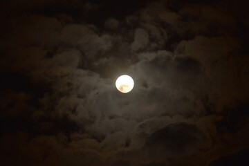 full moon covering by cloud floating on sky in night background