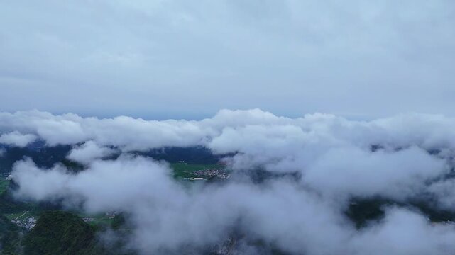 Authentic Guangxi Landscape: After the Rain, Clouds Linger at Hilltop Level Around a Town