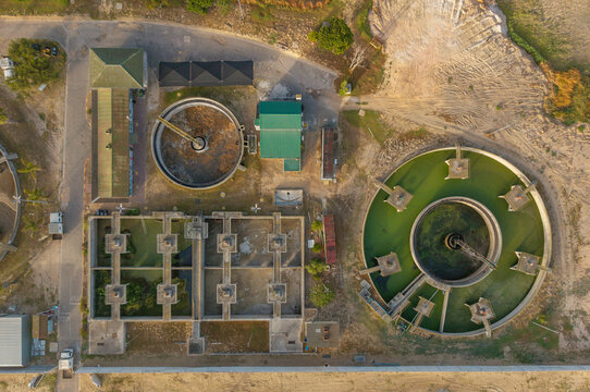 Aerial view of the water treatment plant's circular tanks and rectangular settling basins, contrasting in form and function, Kraaifontein, Western Province, South Africa.