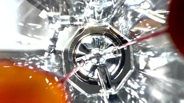 View from beneath a portafilter as espresso drips into coffee glass