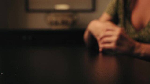 The woman removes the wedding ring from her finger. A feeling of love fading.