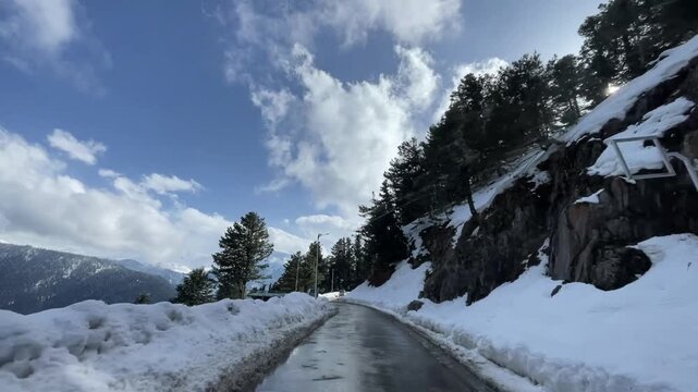Scenic road and pathway leading to Aru Valley surrounded by lush meadows, pine forests, rivers, and Himalayan mountain landscapes near Pahalgam, Kashmir.