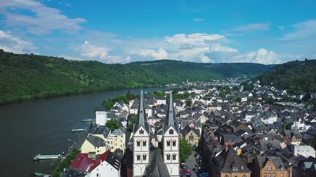 A panoramic aerial view soaring over the church spire of Boppard Church beside the Rhine Valley