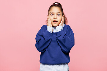 Little shocked surprised kid girl 8-9 years old wears blue shirt have fun put hand on face isolated...