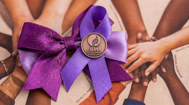Un elegante lazo morado de sat&eacute;n brillante, s&iacute;mbolo universal del D&iacute;a Internacional de la Mujer. Representa la conmemoraci&oacute;n del 8M y la lucha continua por la igualdad de derechos, la justicia.