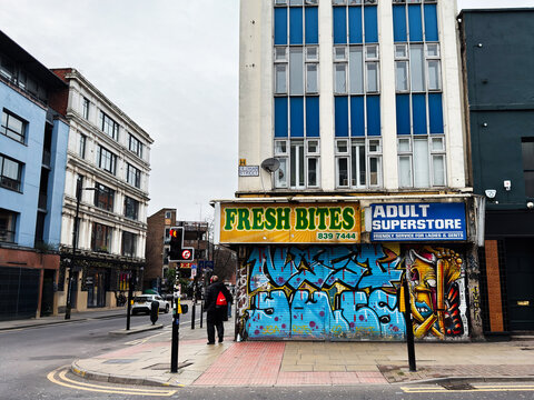 Urban Oldham street scene in Manchester featuring Fresh Bites and an adult store storefront with graffiti artwork