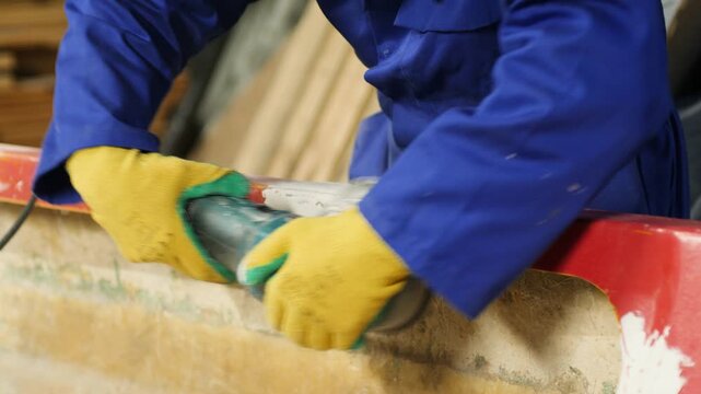 Sanding filler fiberglass boat gunwale using electrical sander