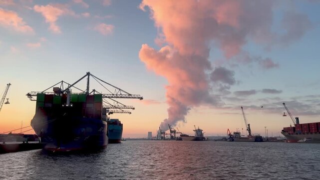 A nuclear power plant with cooling towers located next to water, symbolizing atomic energy. Nuclear energy and its impact on sustainability and the environment..Doel Belgium