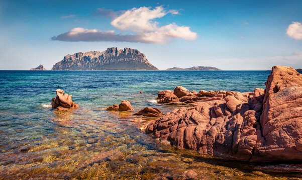 Astonishing summer view of Tavolara island from Spiaggia del dottore beach. Impressive morning scene of Sardinia island, Italy, Europe. Vacation concept background.