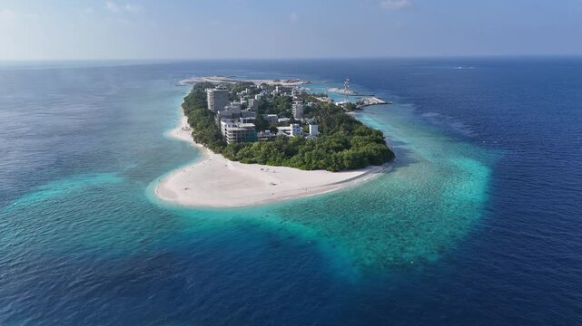 Aerial drone view of Ukulhas island Maldives surrounded by turquoise lagoon and deep blue ocean