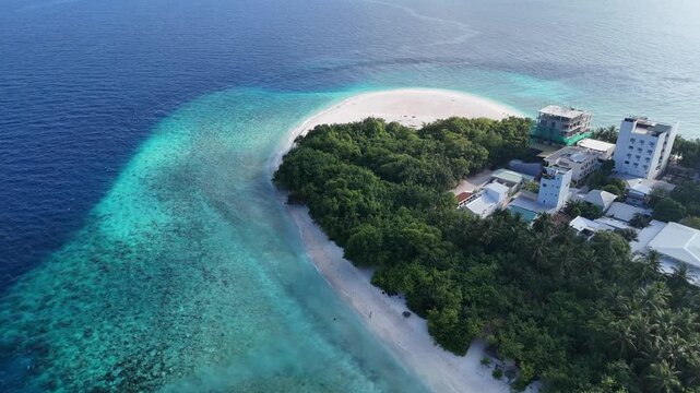 Aerial drone view of Ukulhas island Maldives surrounded by turquoise lagoon and deep blue ocean