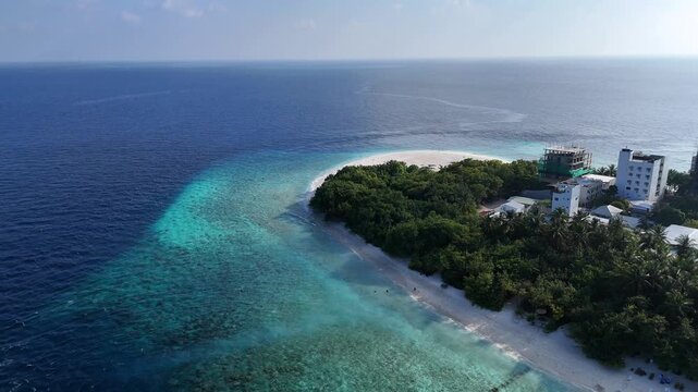 Aerial drone view of Ukulhas island Maldives surrounded by turquoise lagoon and deep blue ocean