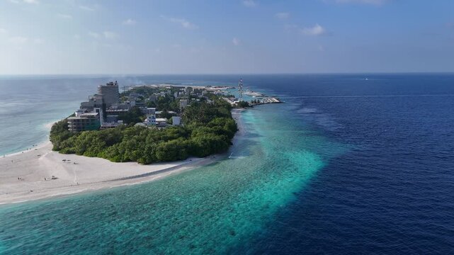 Aerial drone view of Ukulhas island Maldives surrounded by turquoise lagoon and deep blue ocean