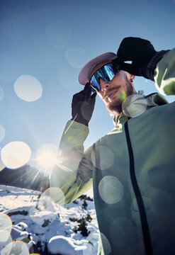Man bearded runner in the winter mountains