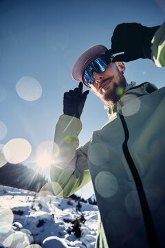 Man bearded runner in the winter mountains