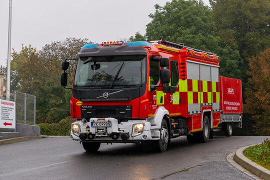 Volvo FL fire truck 349[P]08 from OSP Sulisławice with logistics trailer on wet road near City Stadium in Kalisz, professional firefighting vehicle.