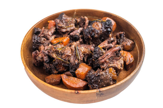 Homemade veal oxtail ragout in wooden bowl, gelatin rich slow cooked meat with vegetables, overhead food photo