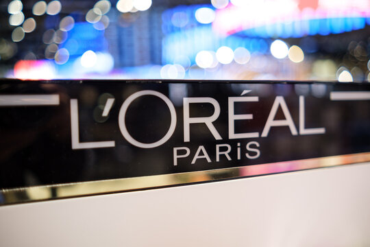 Moscow, Russia - January 25, 2026: L'Oreal Paris brand logo displayed prominently at a cosmetics exhibition with blurred background lights