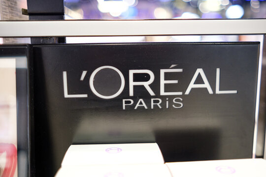 Moscow, Russia - January 25, 2026: L'Oreal Paris brand logo displayed prominently on a black background in a retail setting with blurred lights