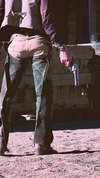 cowboy with revolver shooting on the floor