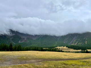 Clouds lying on the tops of the Altai mountains