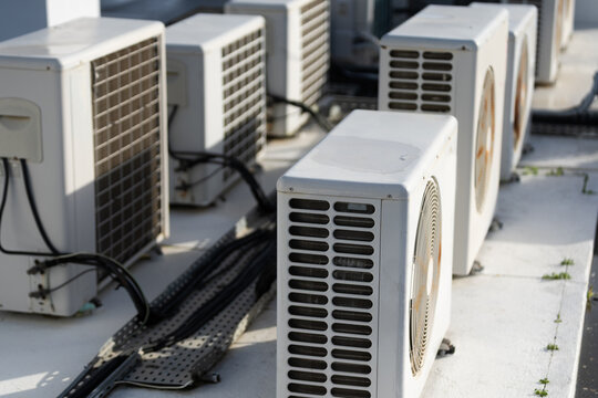 HVAC systems operate on a rooftop with industrial air conditioning units providing ventilation and cooling for commercial buildings and urban infrastructure.