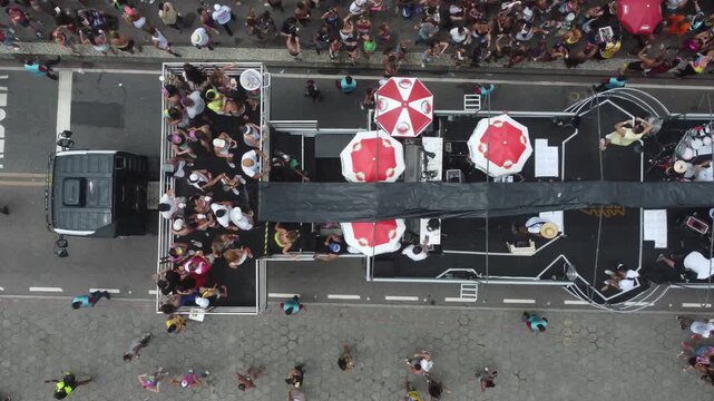 Top-down drone shot revealing carnival crowd and music truck, Rio de Janeiro
