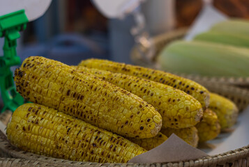 A basket of yellow corn on a table
