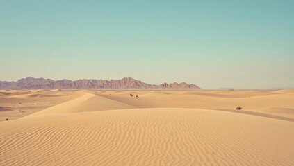 Mountains and Sand Dunes Stretch Across the Desert Under a Clear Sky