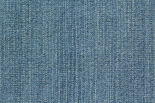Blue denim fabric texture with visible twill weave and classic textile pattern