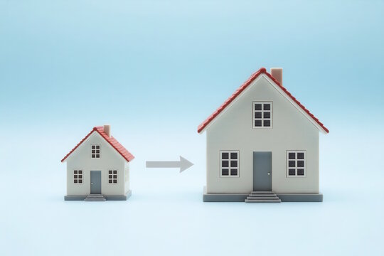 Small house transition to bigger property on blue background, upsizing home concept