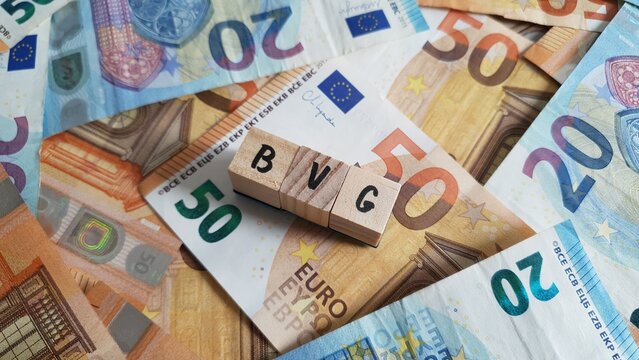 BVG acronym made of wooden letter cubes on pile of Euro banknotes. Betriebsrentenversorgungsgesetz (Occupational Pension Scheme Act)