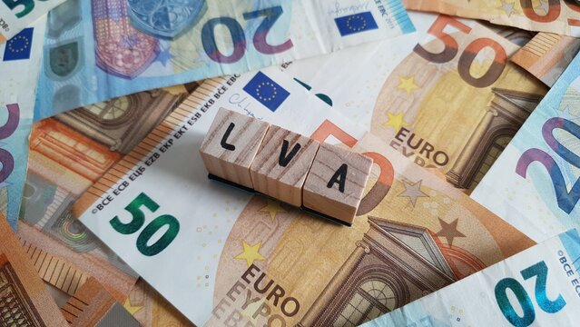 LVA acronym made of wooden letter cubes on pile of Euro banknotes. Landwirtschaftliche Sozialversicherung (Agricultural Social Insurance)