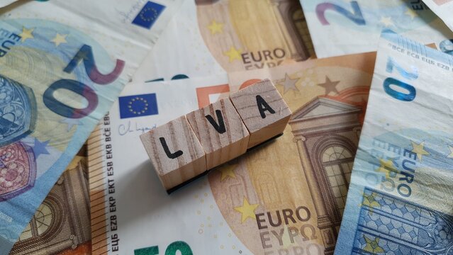 LVA acronym made of wooden letter cubes on pile of Euro banknotes. Landwirtschaftliche Sozialversicherung (Agricultural Social Insurance)