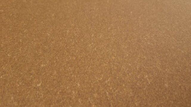 Warm brown leatherboard sheet surface with fine pressed fiber texture.