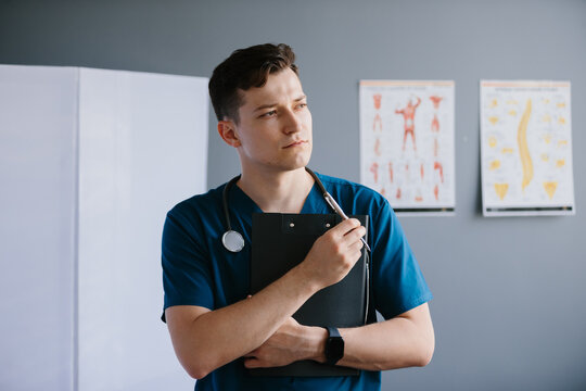 Young doctor thinking new medical solutions in clinic