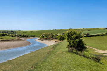 A view along the Cuckmere River in Sussex, on a sunny spring day