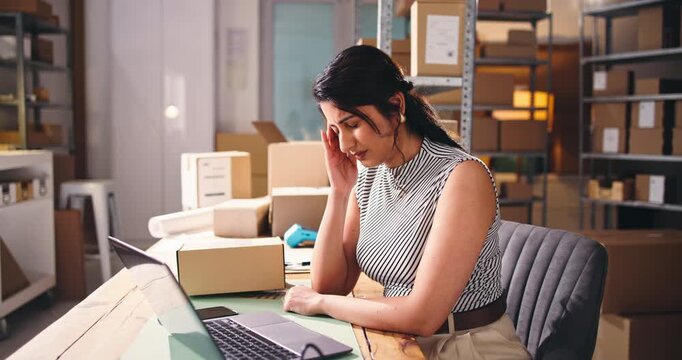 Ecommerce, headache or woman in office with laptop for logistics fail, distribution backlog or delay. Computer, tired person and migraine for courier problem, supplier frustration or reputation risk.