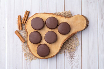 Brazilian Pao de Mel or chocolate covered honey cookies over a wooden table
