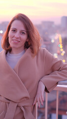 Attractive young woman portrait on a building rooftop in the evening