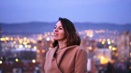 A young woman in the city in the evening