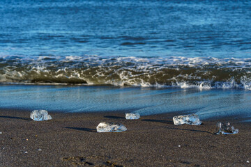 Jewelry ice scattered on sandy beach at Tokachi River estuary, Hokkaido, Japan © ibuki
