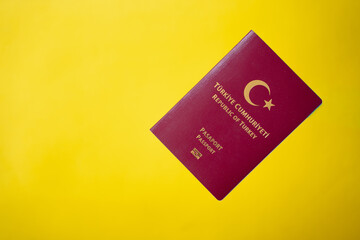 Republic of T&uuml;rkiye burgundy passport on the yellow table