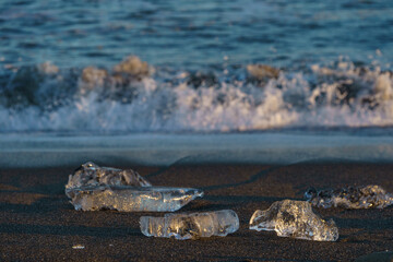 Jewelry ice scattered on sandy beach at Tokachi River estuary, Hokkaido, Japan © harumachi