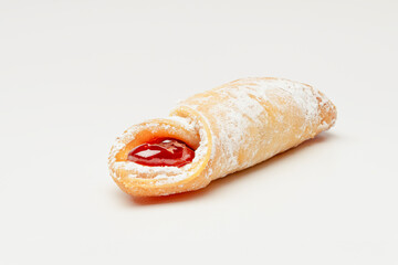 Closeup of a Kiffle Filled with Raspberry Jam on a White Background