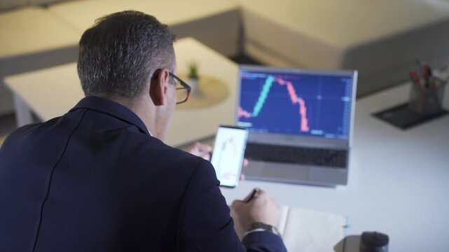 Businessman Analyzing Crypto Market Trends on Laptop
