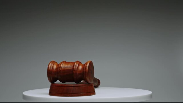 Wooden gavel on display on a round table in a quiet room for auction events or meetings