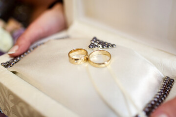 Gold Wedding Rings with Pearls in White Ring Box. Gold wedding rings with pearl decor in an elegant white ring box held in hands symbolizing marriage ceremony luxury romance and classic wedding tradit